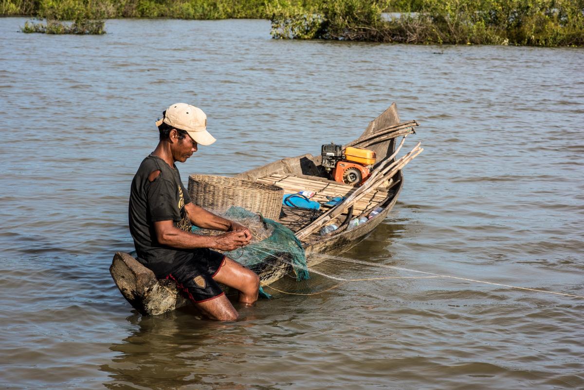 A fisherman checking his net, Cambodia