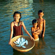Children bathing with a basketful of fish