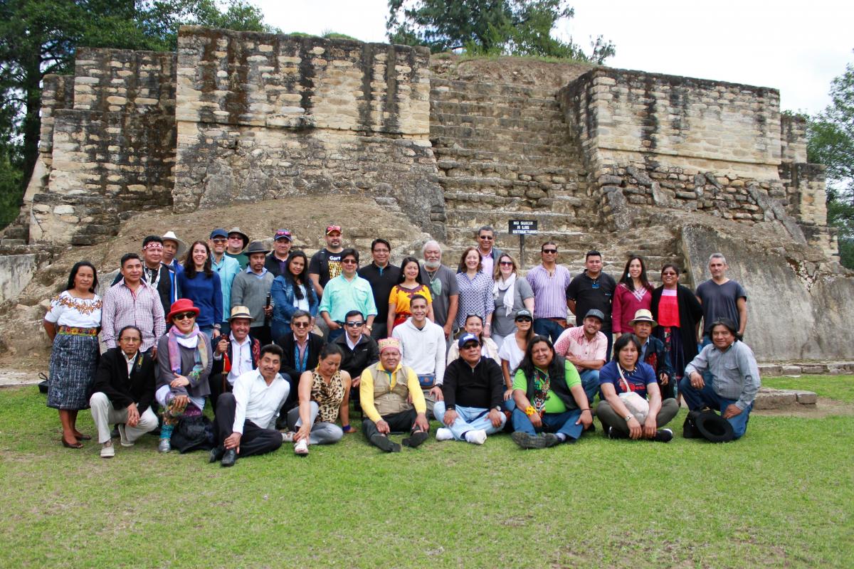 people posing in front of Maya ruin