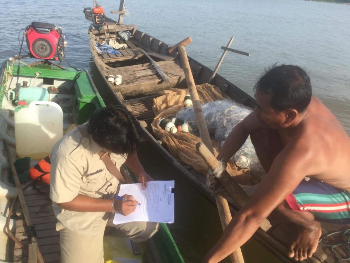 A project staff is working with a local fisher