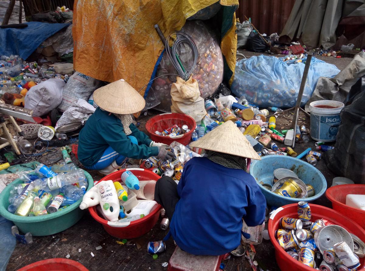 Waste pickers are classifying plastic waste for recycling in Cam Ha Landfill