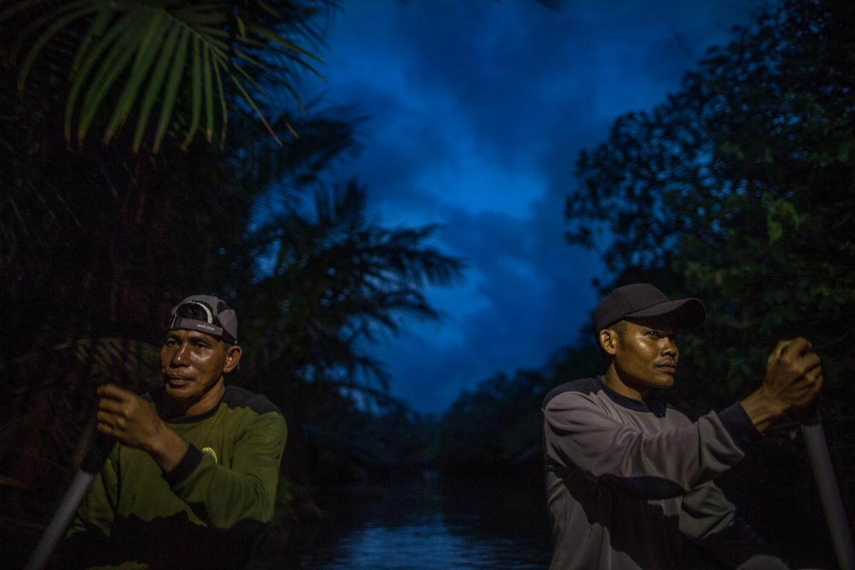 Rangers on a river patrol searching for Javan Rhino in Ujung Kulon National Park