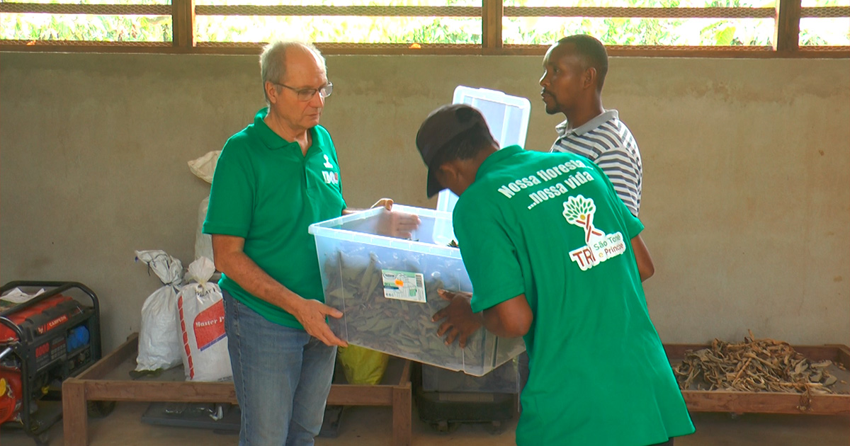 A group of men carrying a plastic container
Description automatically generated