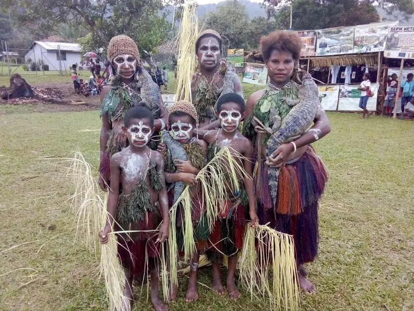 Papuan people with freshwater crocodiles in the Sepik River, Papua New Guinea