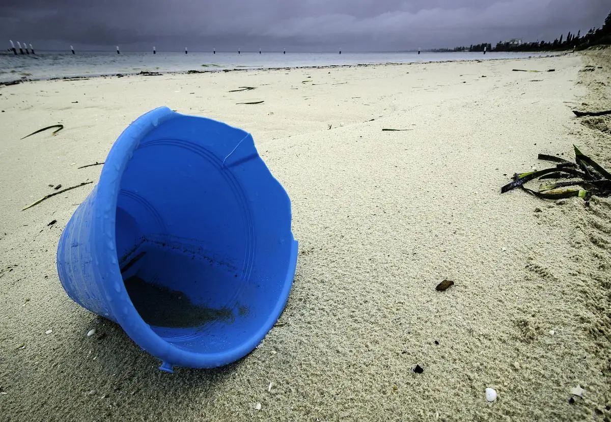 Plastic bucket on beach