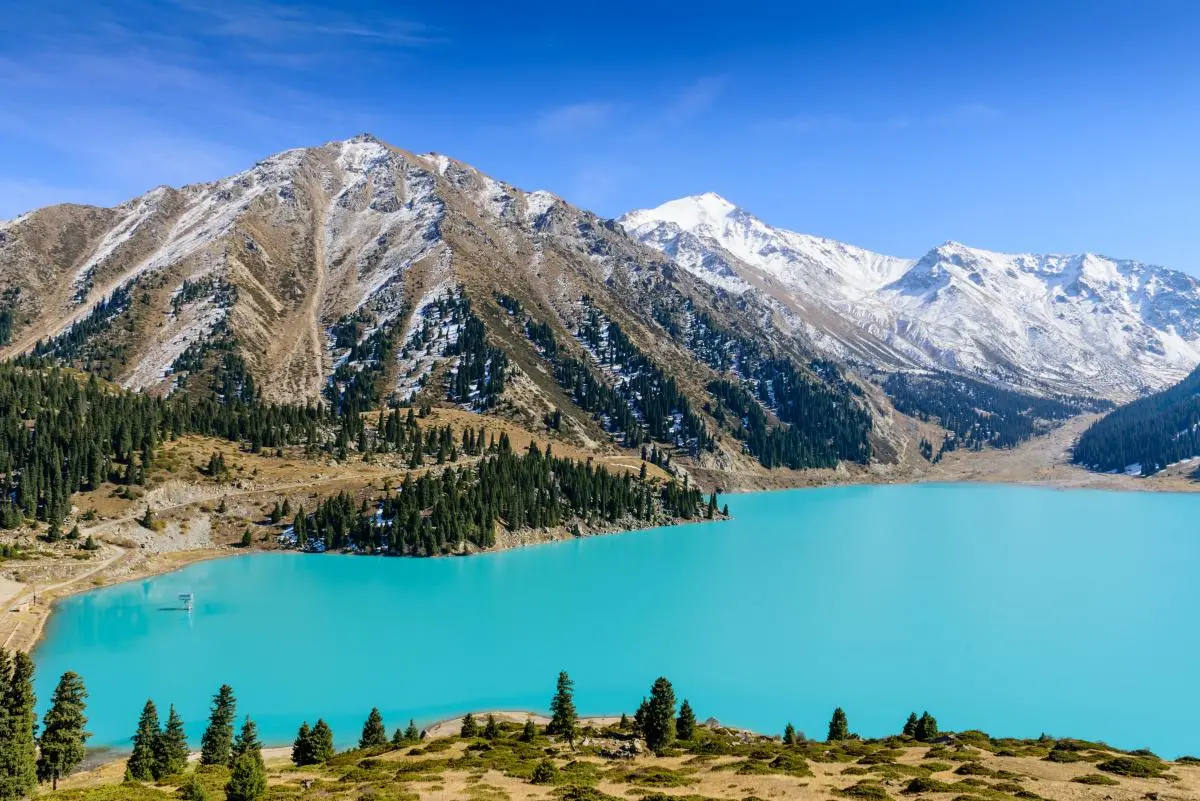 mountain with blue lake and pine trees