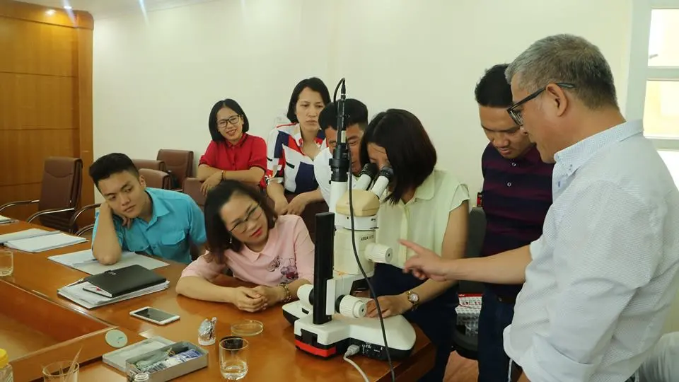 Trainees are checking samples via microscope after field visit