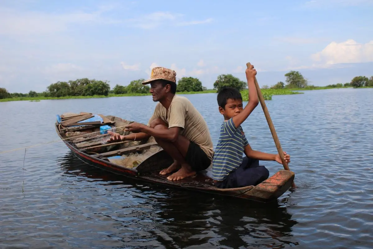A fisher folk with his son at Boeung Chhmar Ramsar site in Cambodia 