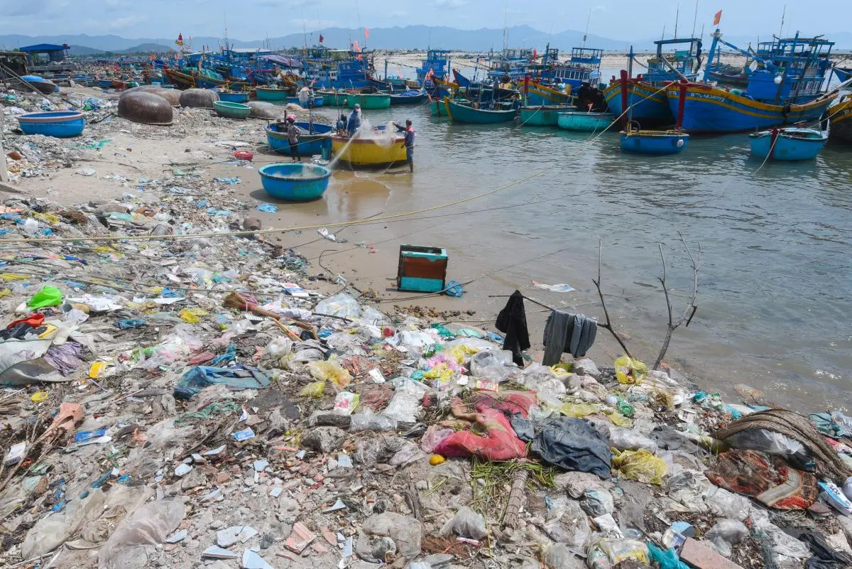A boat dock in Binh Thuan beach is fully covered with plastic waste 