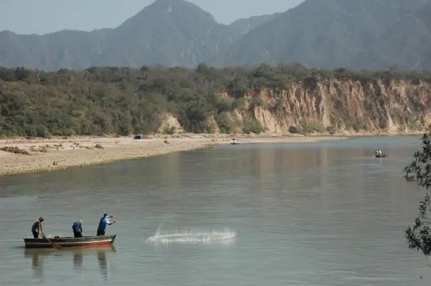 Fishers using a cast net in the Pilcomato River, Bolivia.
