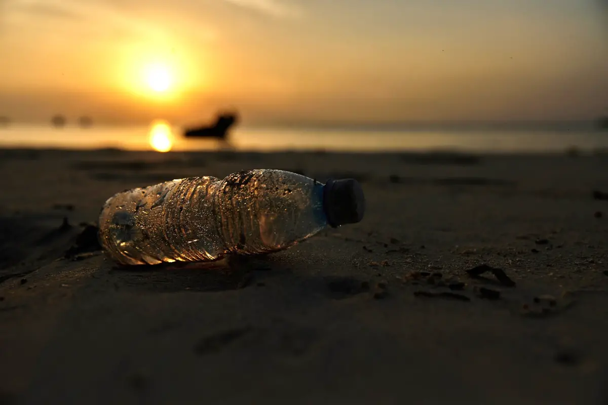 Plastic bottle on beach sand
