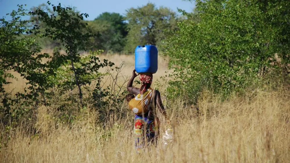 Woman carrying Water container