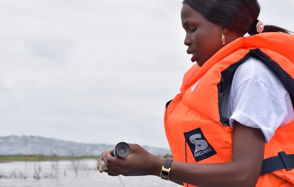 In a wooden boat on the estuary of the Densu River in Ghana, Cecila dips a salinator into the water and declares that the salinity is only two parts per thousand